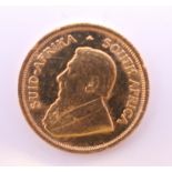 A 1985 1/10 ounce fine gold krugerrand coin.
