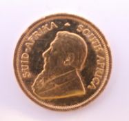 A 1985 1/10 ounce fine gold krugerrand coin.