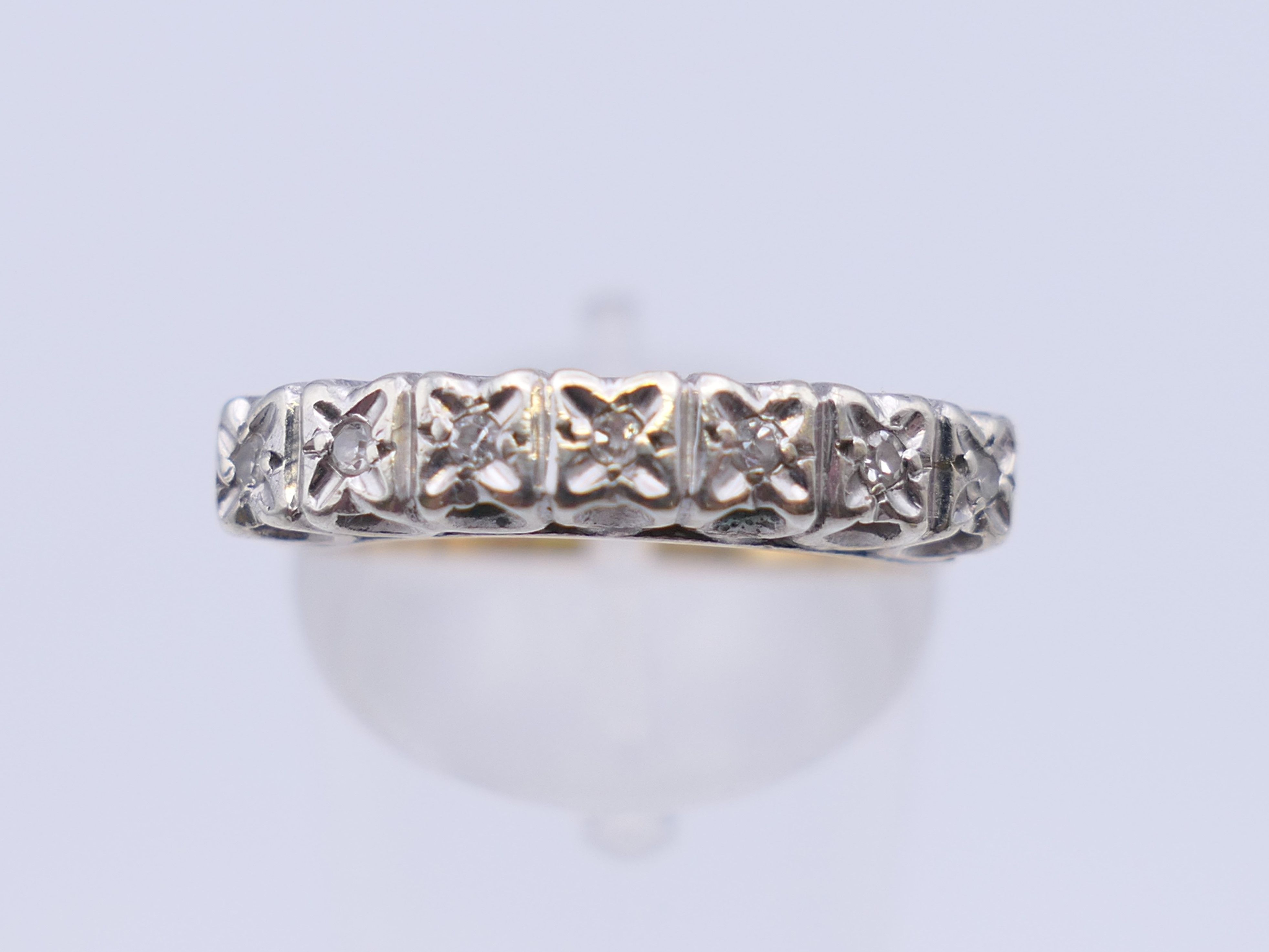 A 9 ct gold seven stone diamond ring. Ring size N/O. 2.5 grammes total weight. - Image 3 of 8
