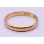 A 22 ct gold wedding band. Ring size M. 3.4 grammes.