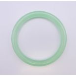 An icy celadon jade bangle. 6 cm internal diameter.