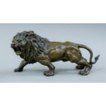A bronze model of a lion. 31 cm long.