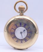 A gold plated half hunter pocket watch. 5 cm diameter.