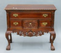 A carved mahogany lowboy. 90 cm wide.