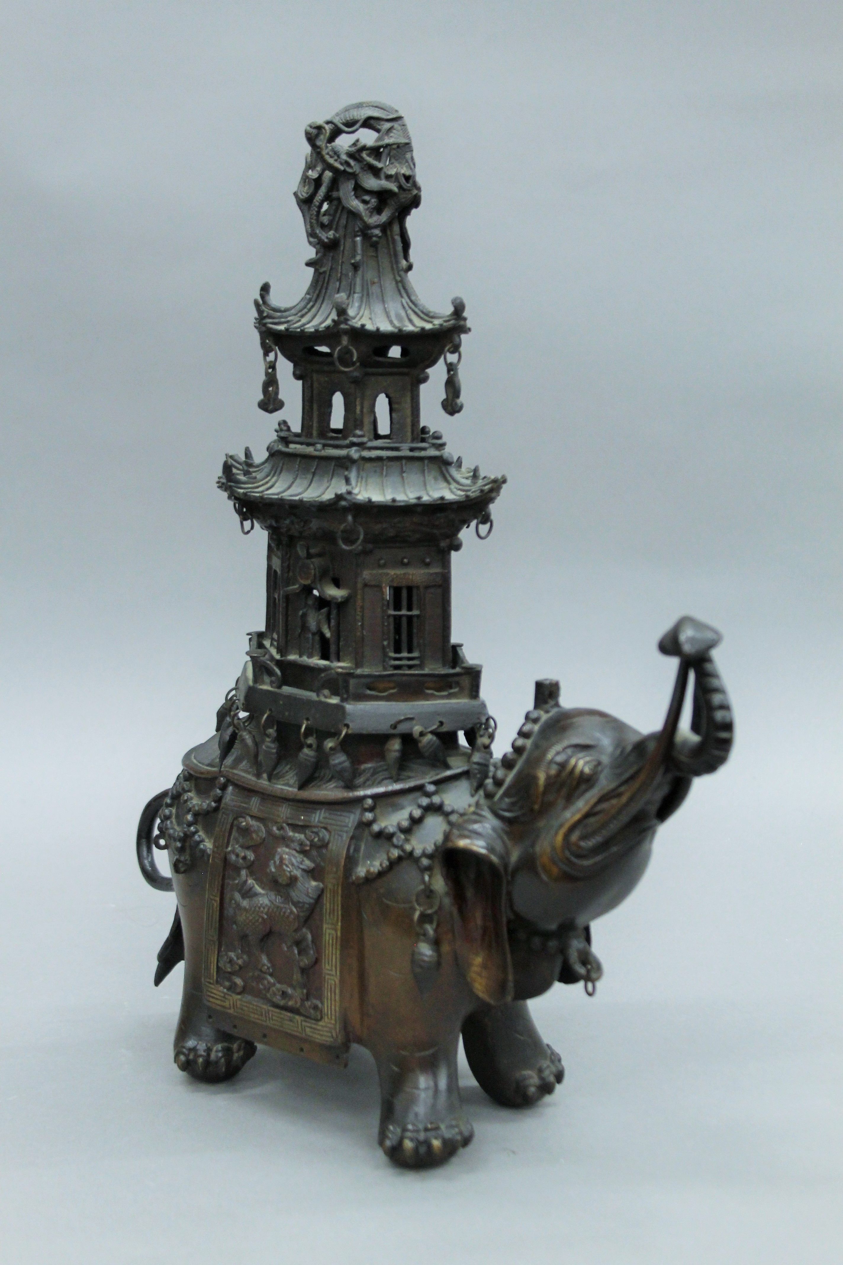 A Chinese bronze censer formed as an elephant with a pagoda on its back. 38 cm high.