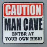 A cast iron Man Cave sign. 24.5 cm wide.