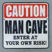 A cast iron Man Cave sign. 24.5 cm wide.