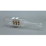 A glass ship in a glass bottle. 22.5 cm long.