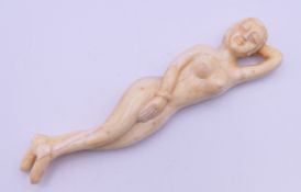 A bone medical figure of a nude female. 13 cm long.