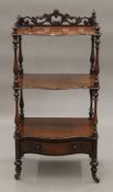 A Victorian rosewood three-tier whatnot. 56 cm wide.