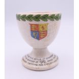 A WWI egg cup with inscription to base "Made by the girls of Staffordshire during the winter of