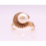 A 9 ct gold ring set with a 7 mm cultured pearl. Ring size I. 3.5 grammes total weight.