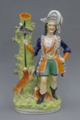 A large 19th century Staffordshire pottery spill figure, The Otter Hunter. 43 cm high.