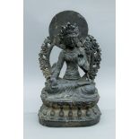 A large 18th century or earlier carved stone model of Buddha. 37 cm high.