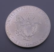 A 2015 US fine silver 1 ounce dollar coin.