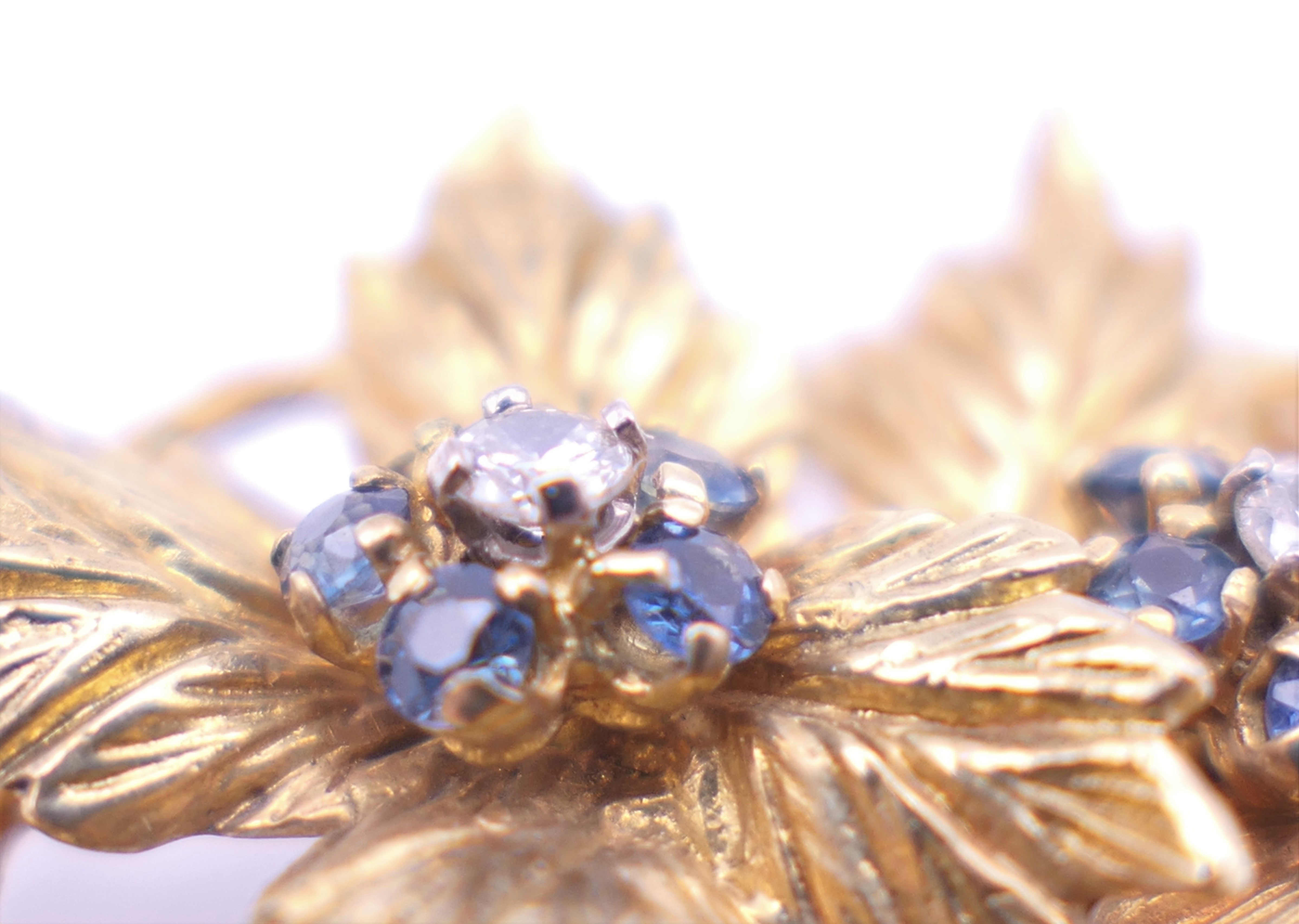 A Kutchinsky 18 ct gold diamond and sapphire set matching brooch and clip earrings of floral form. - Image 4 of 11