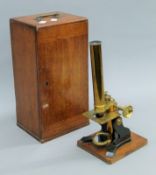 A Victorian mahogany cased brass microscope. The case 33.5 cm high.
