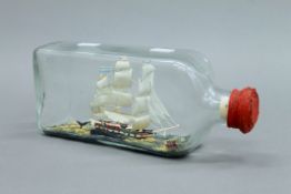 A whaling ship catching a whale in a glass bottle. 24 cm long.