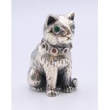 A silver pin cushion formed as a cat (lacking pad). 2.5 cm high.