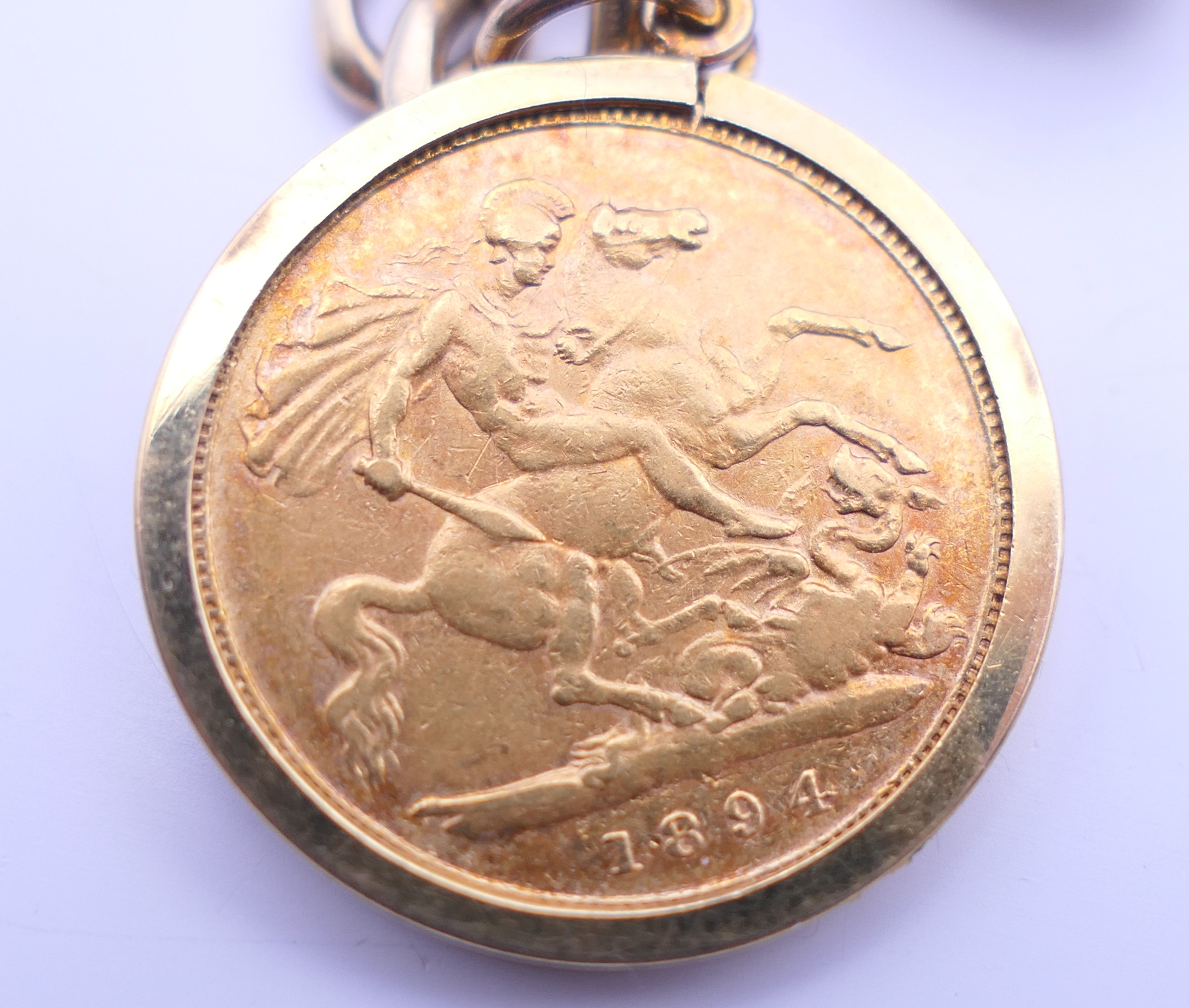 A 9 ct gold charm bracelet, set with various charms and an 1894 half sovereign. 25. - Image 5 of 6