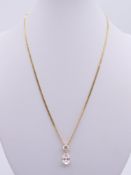 A 14 K gold two stone pendant necklace. Chain 44 cm long, pendant 1.5 cm high. 5.