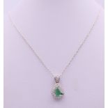 A 14 ct white gold diamond and emerald Art Deco style pear shaped pendant on chain. Pendant 2.