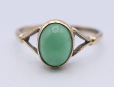 A 9 ct gold cabochon emerald ring. Ring size N. 1.7 grammes total weight.