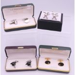 Four boxed pairs of cufflinks.