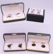 Four boxed pairs of cufflinks.