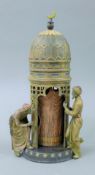 A cold painted bronze model of a tower, enclosing a naked lady. 31 cm high.