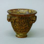 A libation cup. 8 cm high.