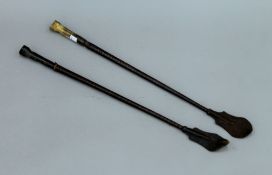 Two horn handled riding crops, the handles formed as horses hooves. The longest 57.5 cm.
