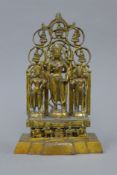 A gilt bronze shrine depicting three deities. 28 cm high.
