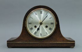 An early 20th century oak mantle clock. 35 cm wide.