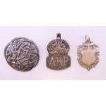 Two silver brooches and a silver fob.