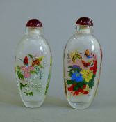 A pair of reverse painted snuff bottles. 9 cm high.