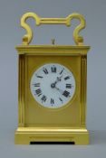 A brass cased repeating carriage clock. 16 cm high.