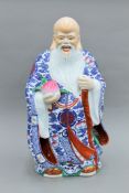 A large Chinese porcelain figure of Shou Lao. 69 cm high.