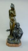 A bronze model of an Arab and a nude woman. 69 cm high.