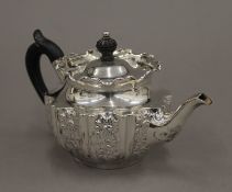 An embossed silver teapot. 18 cm long. 253.4 grammes total weight.