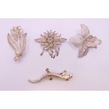 Three silver filigree brooches and a silver brooch formed as a lizard. The latter 5.5 cm long.