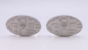 A pair of matt metal cufflinks, stamped Rolex. 2.5 cm wide.