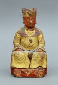 A Chinese painted wooden model of an emperor. 17 cm high.