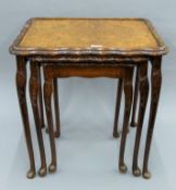 An early 20th century walnut nest of tables. 54 cm wide.
