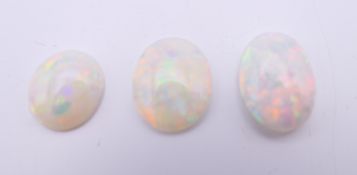 Three loose opals. Each approximately 1 cm long.