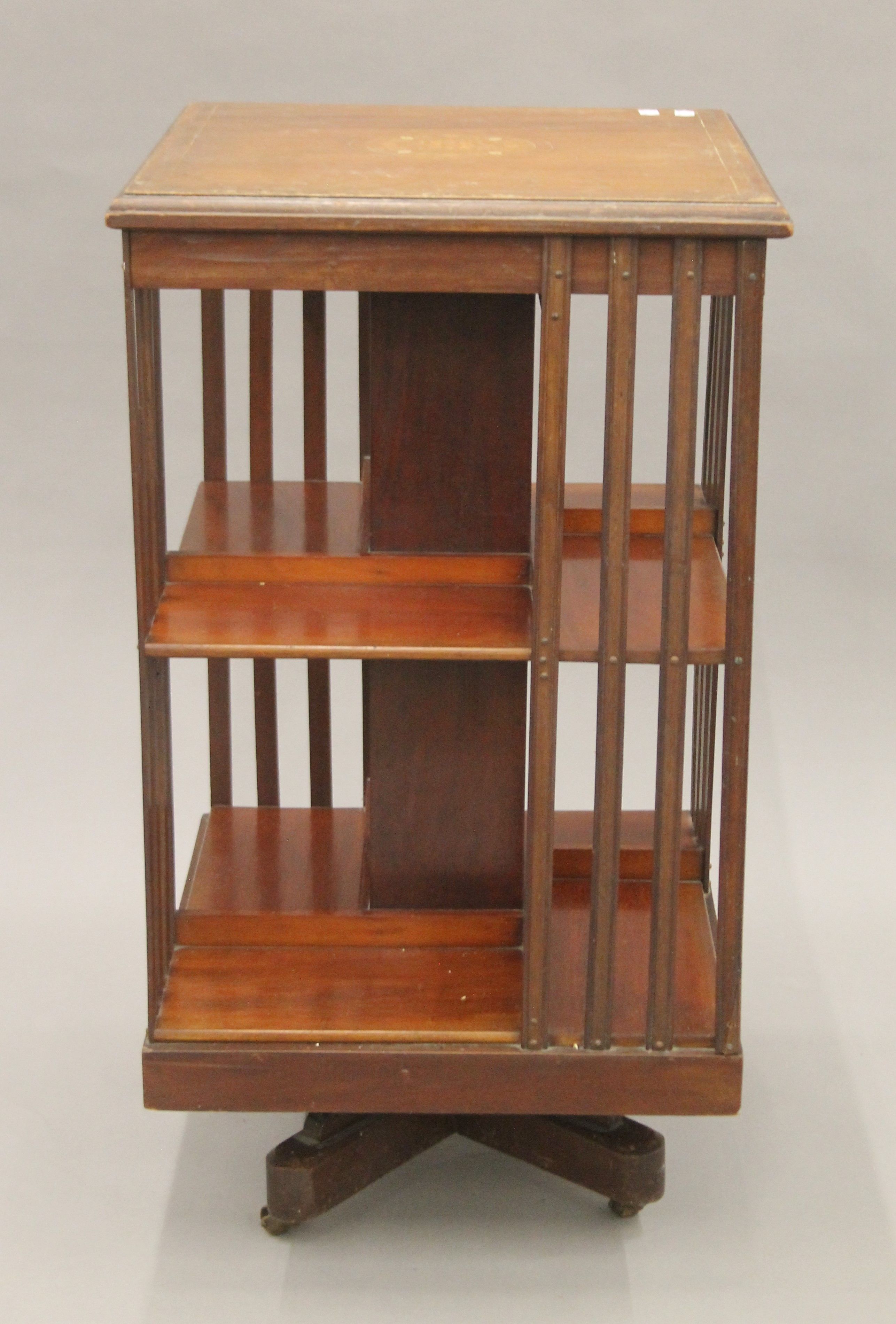 A Victorian inlaid mahogany revolving bookcase. 47.5 cm square.