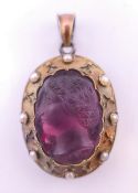 A locket with carved cameo front. 3.5 cm high.