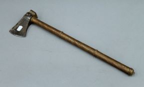 An Eastern antique copper handled axe with gilt decoration. 53 cm long.