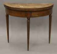 A 19th century Continental walnut demi-lune fold over tea table. 83 cm wide.