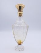 An unmarked 18 ct gold top scent bottle. 10 cm high.